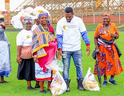 Elderly people seen here returning home in Thohoyandou, Limpopo, with food parcels donated by the Collen Mashawana Foundation.
