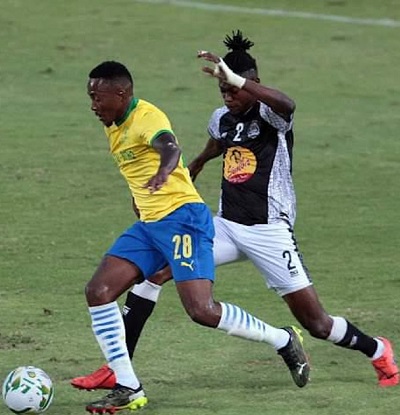 Tussle for ball possession, Mamelodi Sundowns player shields off a TP Mazembe defender